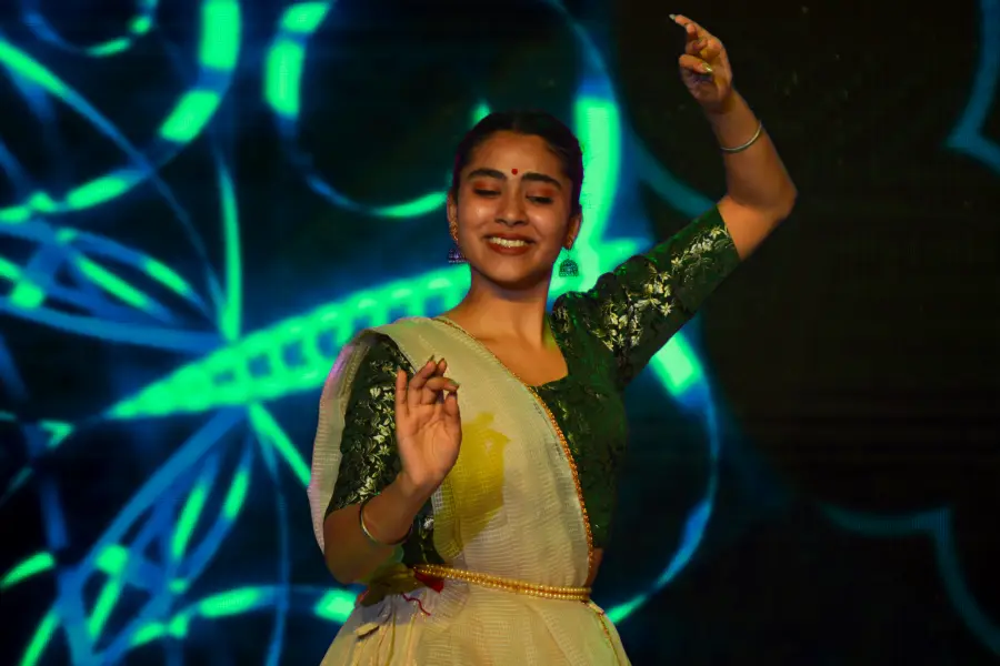 classical dancer mid-movement under green neon